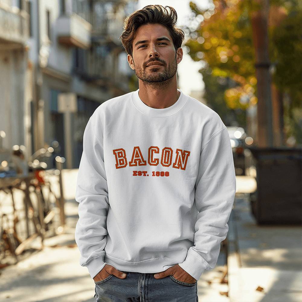 Man wearing a white sweatshirt with 'BACON EST. 1988' text on a city street.