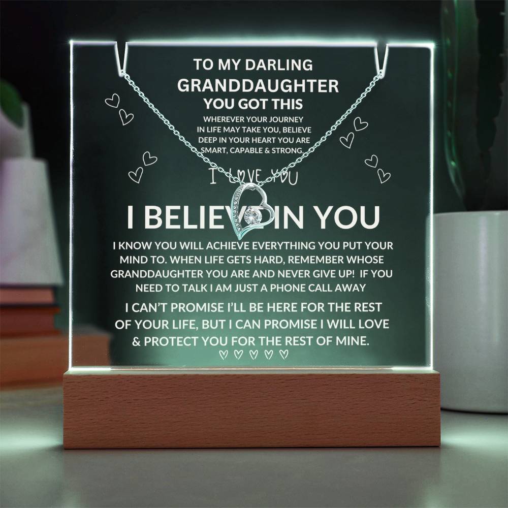 Decorative plaque with engraved message to granddaughter, illuminated on a stand.